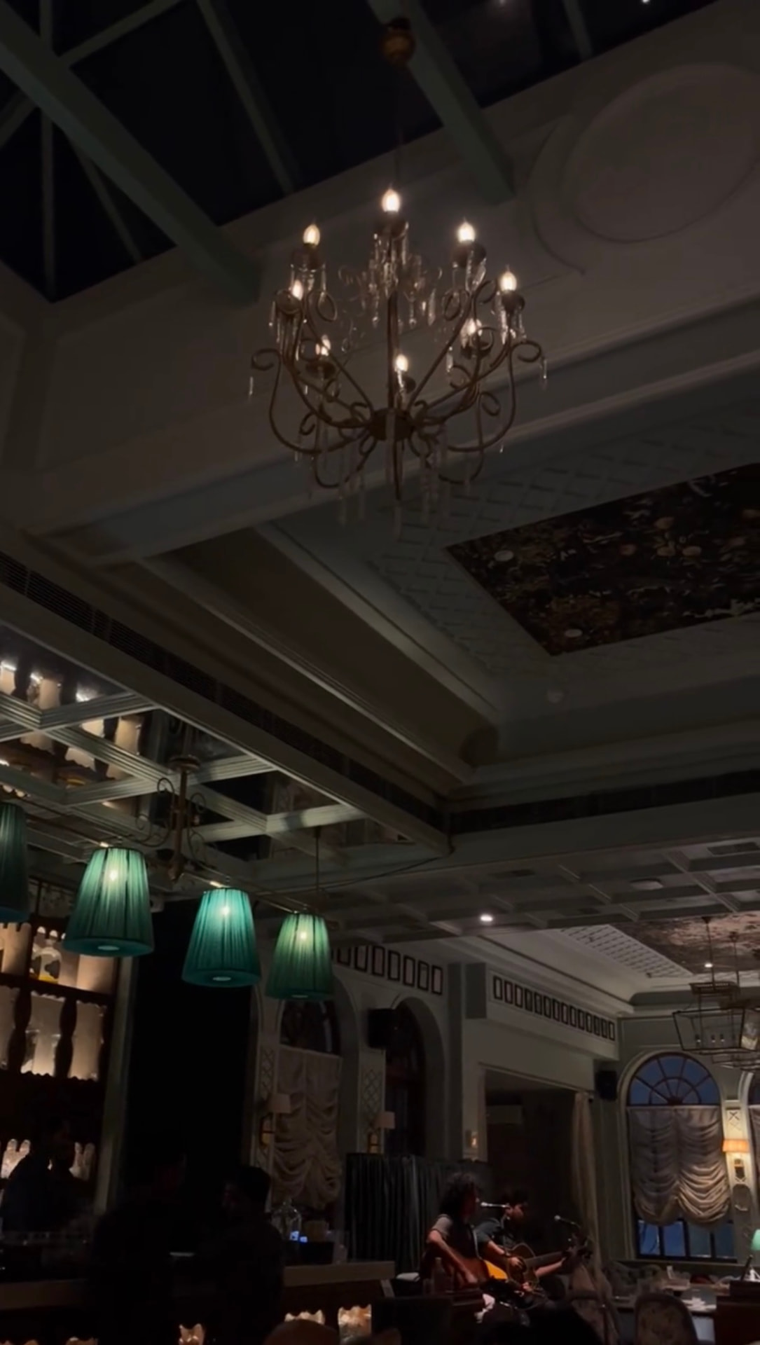 An elegant hospitality interior beneath chandeliers